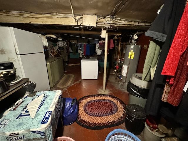 basement featuring gas water heater and white refrigerator