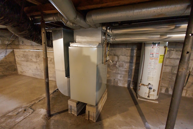 basement featuring gas water heater and heating unit