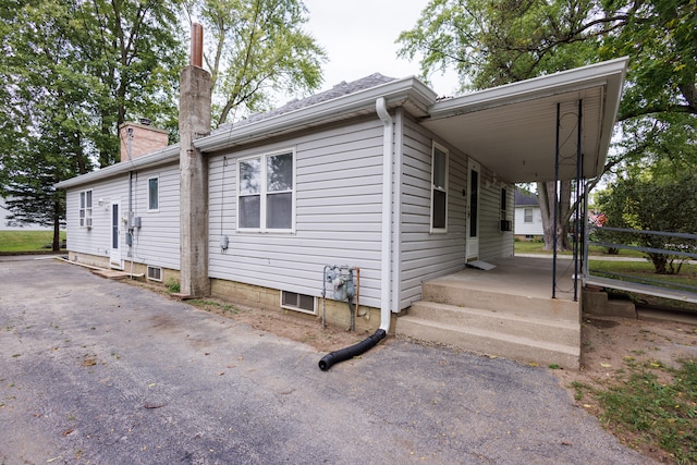 view of home's exterior with a carport