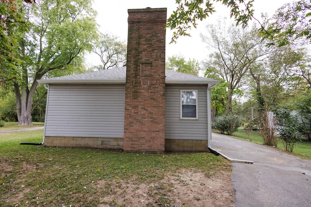 view of side of home featuring a lawn