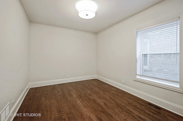 empty room with dark hardwood / wood-style floors