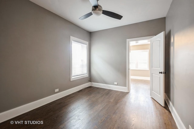 unfurnished room with ceiling fan and dark hardwood / wood-style floors