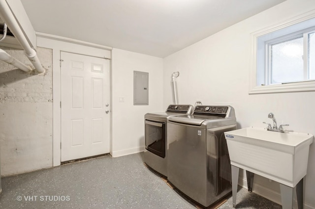 washroom with washing machine and dryer, sink, and electric panel