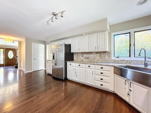 kitchen with tasteful backsplash, sink, dark hardwood / wood-style flooring, white cabinets, and stainless steel fridge with ice dispenser