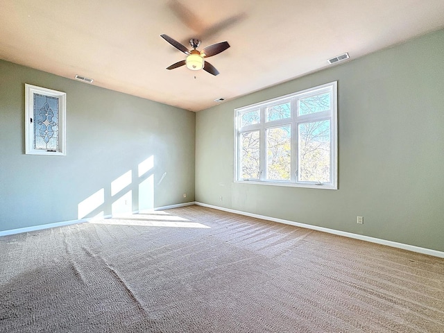 spare room featuring carpet floors and ceiling fan