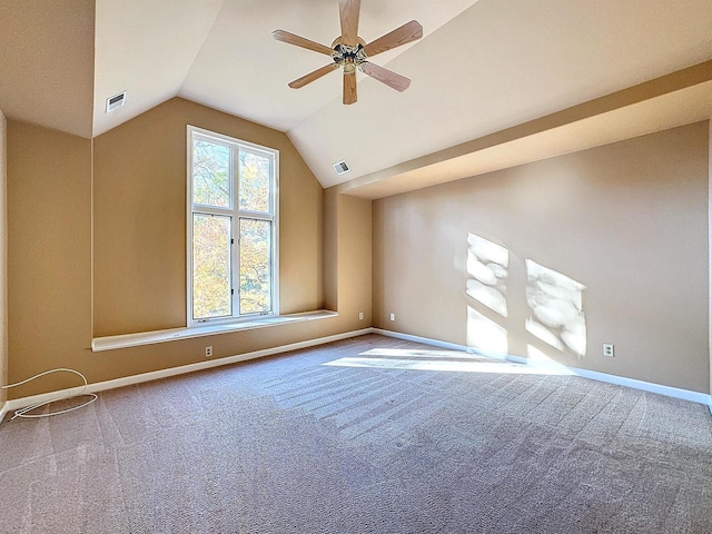 carpeted empty room featuring ceiling fan and vaulted ceiling