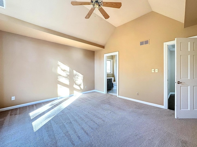 empty room featuring ceiling fan, carpet, and lofted ceiling