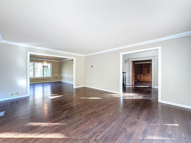 empty room with dark wood-type flooring and crown molding