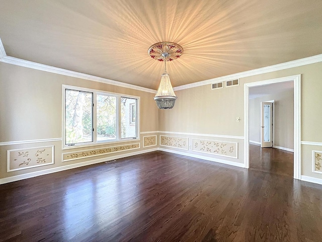 spare room featuring ornamental molding, an inviting chandelier, and dark hardwood / wood-style flooring