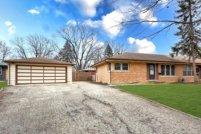 view of front of house featuring a front yard and a garage