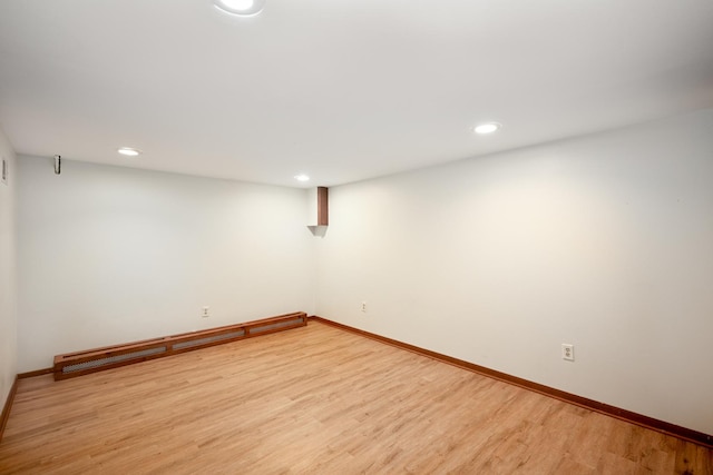 finished basement featuring light wood-style flooring, baseboards, and recessed lighting