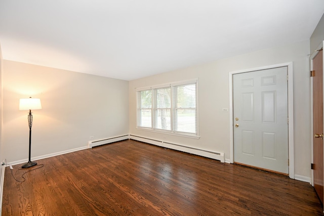 foyer entrance with dark hardwood / wood-style floors and a baseboard heating unit