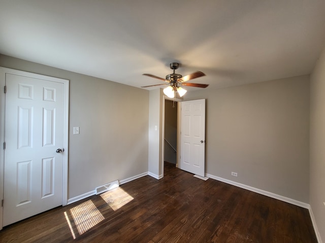 interior space featuring ceiling fan and dark hardwood / wood-style flooring