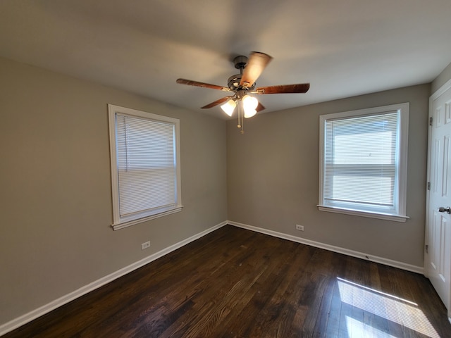 empty room with ceiling fan and dark hardwood / wood-style flooring