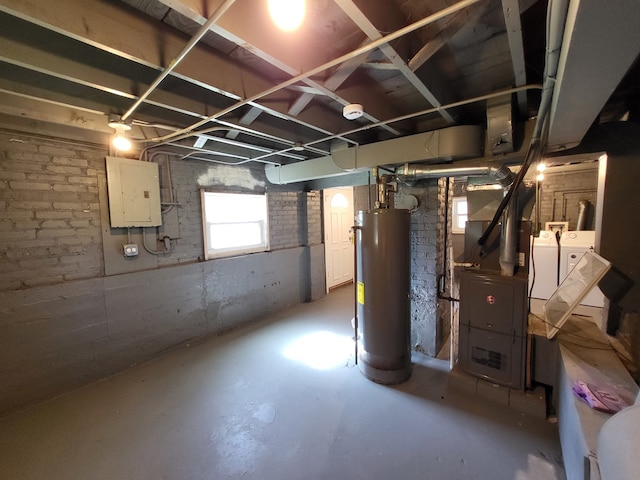 basement with water heater, washer and dryer, and electric panel