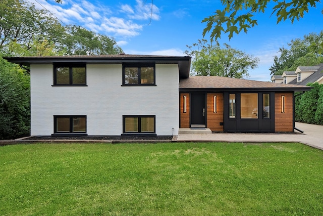 rear view of property with a yard