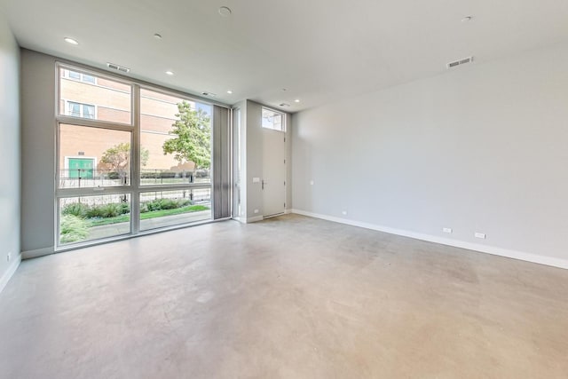 empty room with concrete flooring