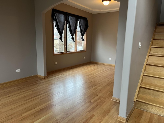 interior space featuring crown molding and light wood-type flooring