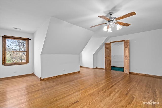 additional living space featuring ceiling fan, lofted ceiling, and light hardwood / wood-style flooring