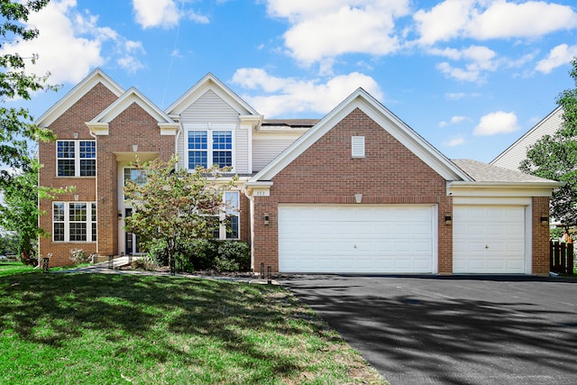 view of front of property with a garage and a front yard