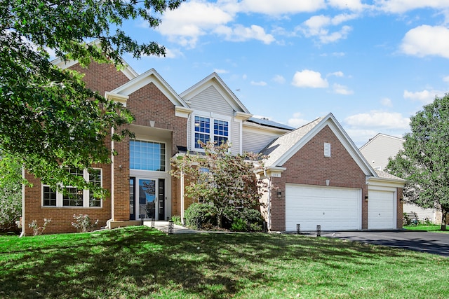 view of front of home with a front yard and a garage