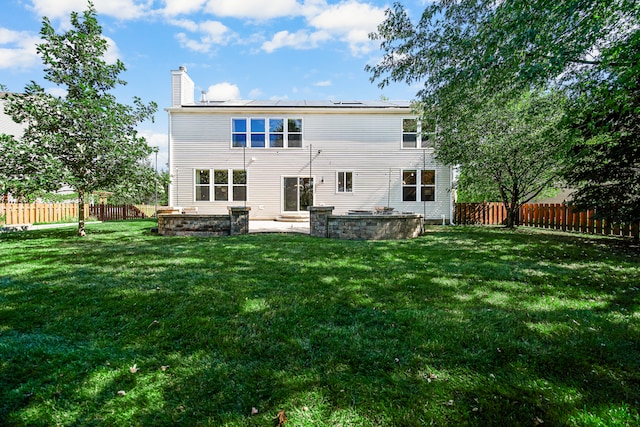 back of house featuring a yard and a patio