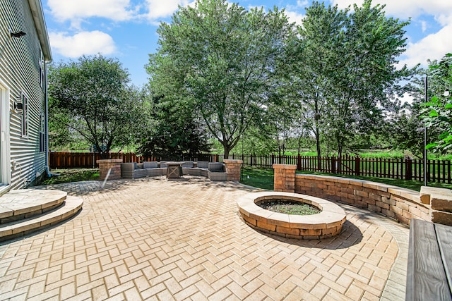 view of patio / terrace with an outdoor living space with a fire pit