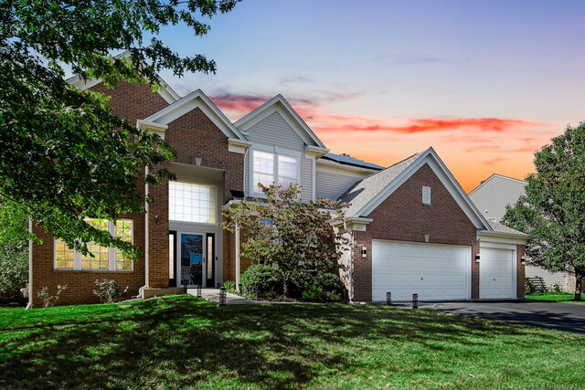 view of front facade featuring a lawn and a garage