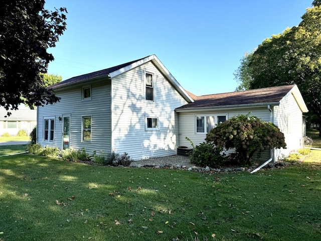 rear view of property featuring a yard