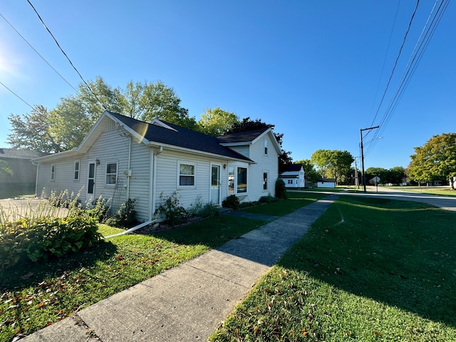 view of side of property with a yard