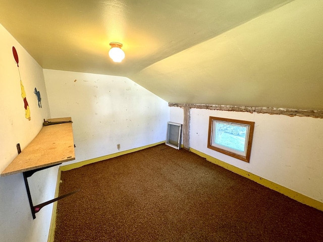 bonus room with baseboards, lofted ceiling, and carpet floors