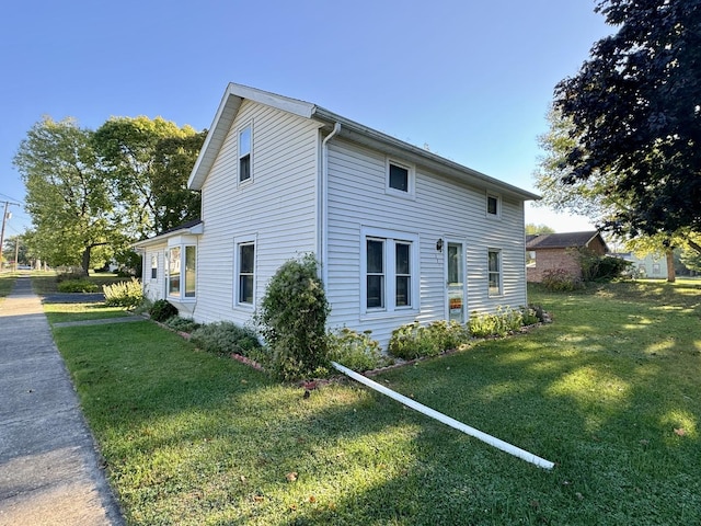 view of side of property featuring a yard