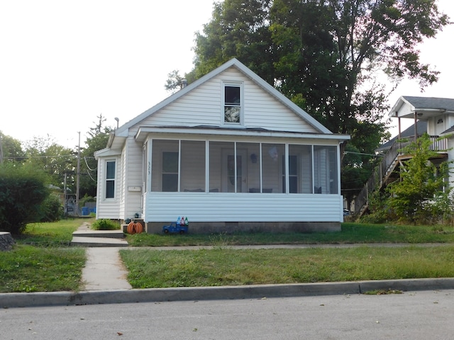 bungalow featuring a sunroom and a front yard