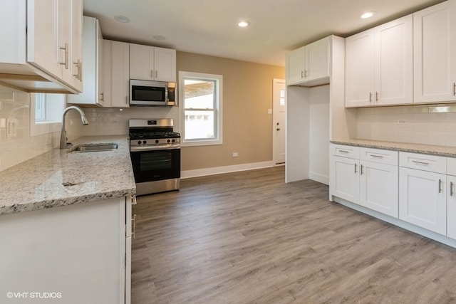 kitchen featuring white cabinets, appliances with stainless steel finishes, and sink