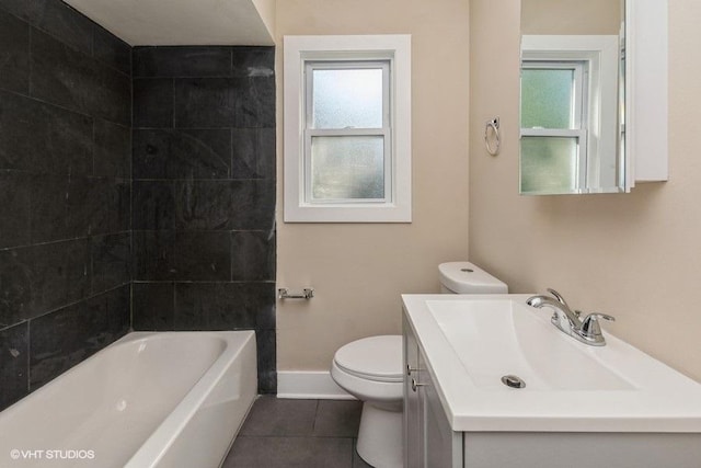 bathroom featuring toilet, vanity, baseboards, and tile patterned flooring