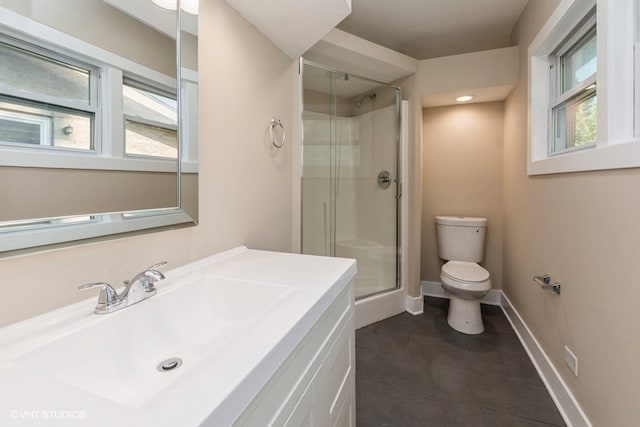 bathroom featuring tile patterned flooring, vanity, toilet, and a shower with shower door