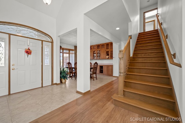 tiled foyer with high vaulted ceiling