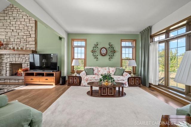 living room with wood-type flooring and a fireplace