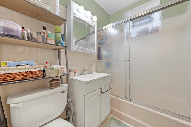 full bathroom with decorative backsplash, vanity, toilet, and bath / shower combo with glass door