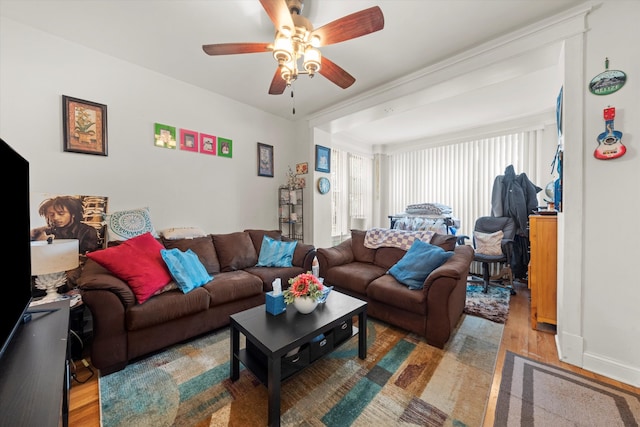 living room with wood-type flooring and ceiling fan