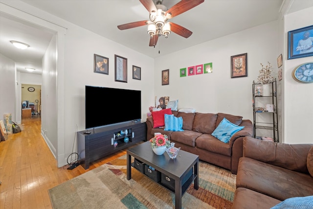 living room featuring ceiling fan and wood-type flooring