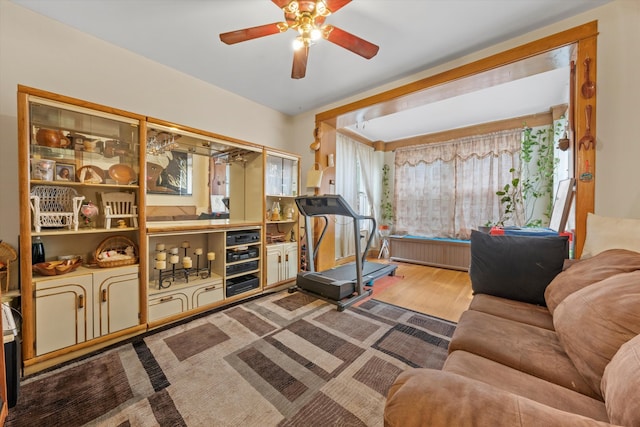 workout room with wood-type flooring and ceiling fan