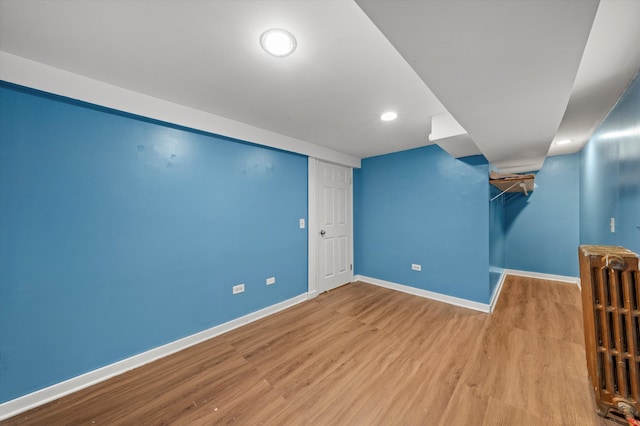 basement with light hardwood / wood-style floors