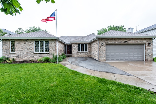 ranch-style house featuring a front yard and a garage