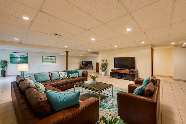 tiled living room with a paneled ceiling