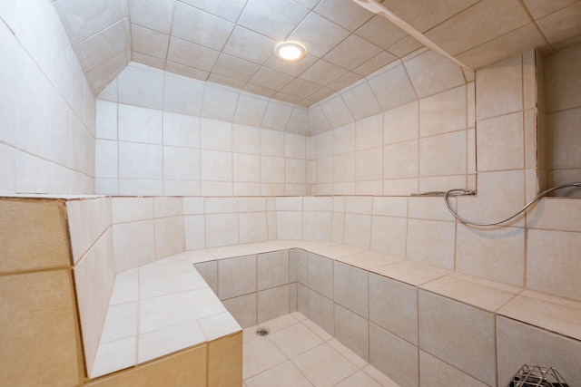 bathroom with tile walls and walk in shower