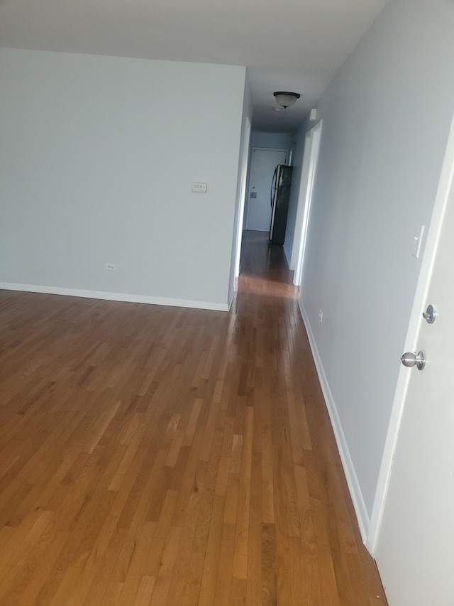 corridor featuring dark hardwood / wood-style flooring