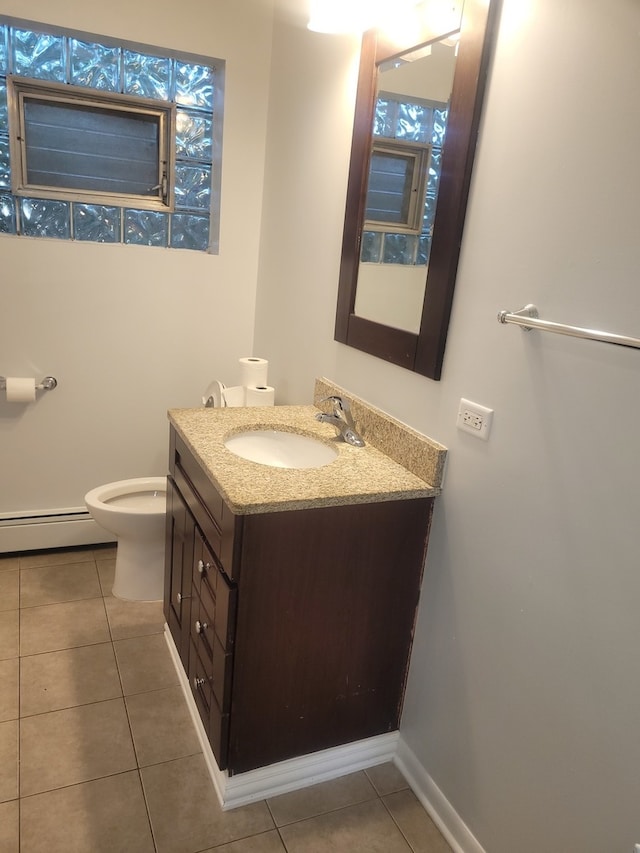 bathroom featuring vanity, toilet, tile patterned floors, and a baseboard heating unit