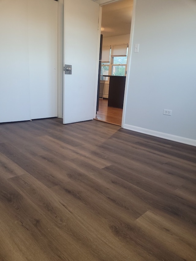 unfurnished room featuring dark hardwood / wood-style flooring