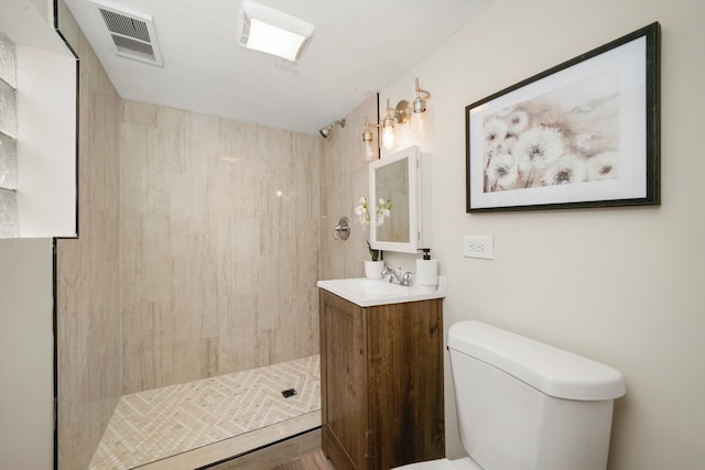 bathroom featuring a shower, vanity, and toilet